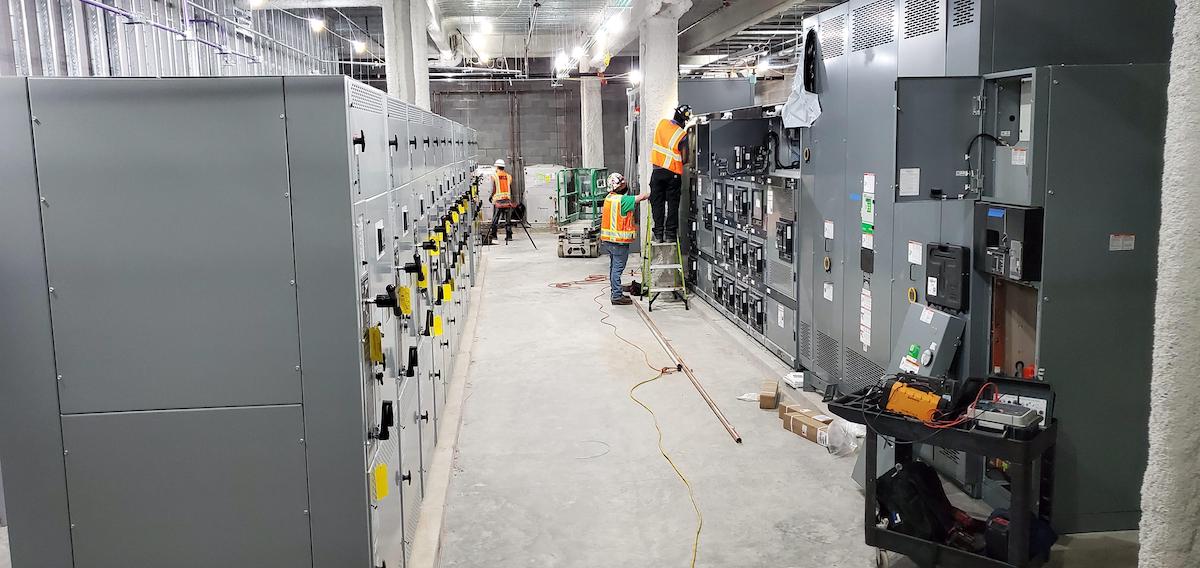 Engineers installing switchgear