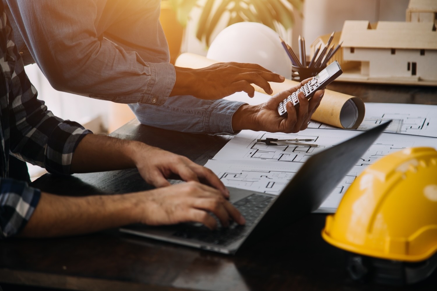 Construction and structure concept of engineer working drawing on blueprint meeting for project working with partner on model building and engineering tools in working site